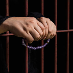 Muslim woman hand in jail