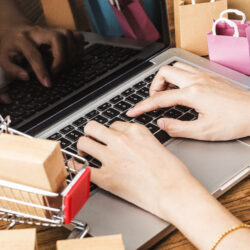 Colorful paper shopping bags in a trolley. Ideas about online sh