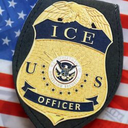 KYIV, UKRAINE – SEPTEMBER 17, 2025 US ICE Officer badge on United States of America flag